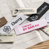 Rectangular woven brand labels on sewing patterns, with Barbershop, Cherry, Ecovibes and Handmade by Sarah designs.